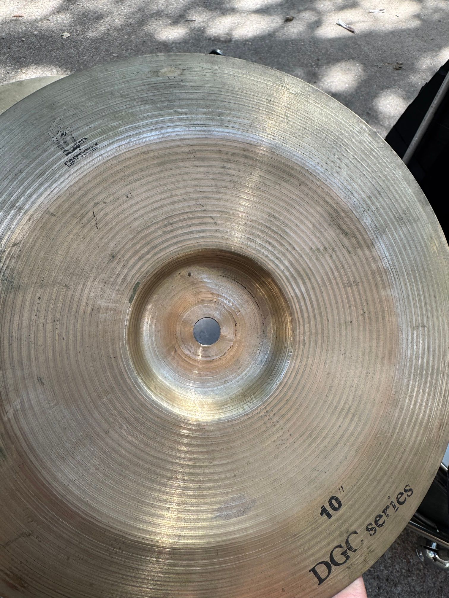 Close-up of a cymbal printed with "10 inch DGC series" near the edge and a Craftsman logo.