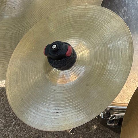 A small splash cymbal on its mount.