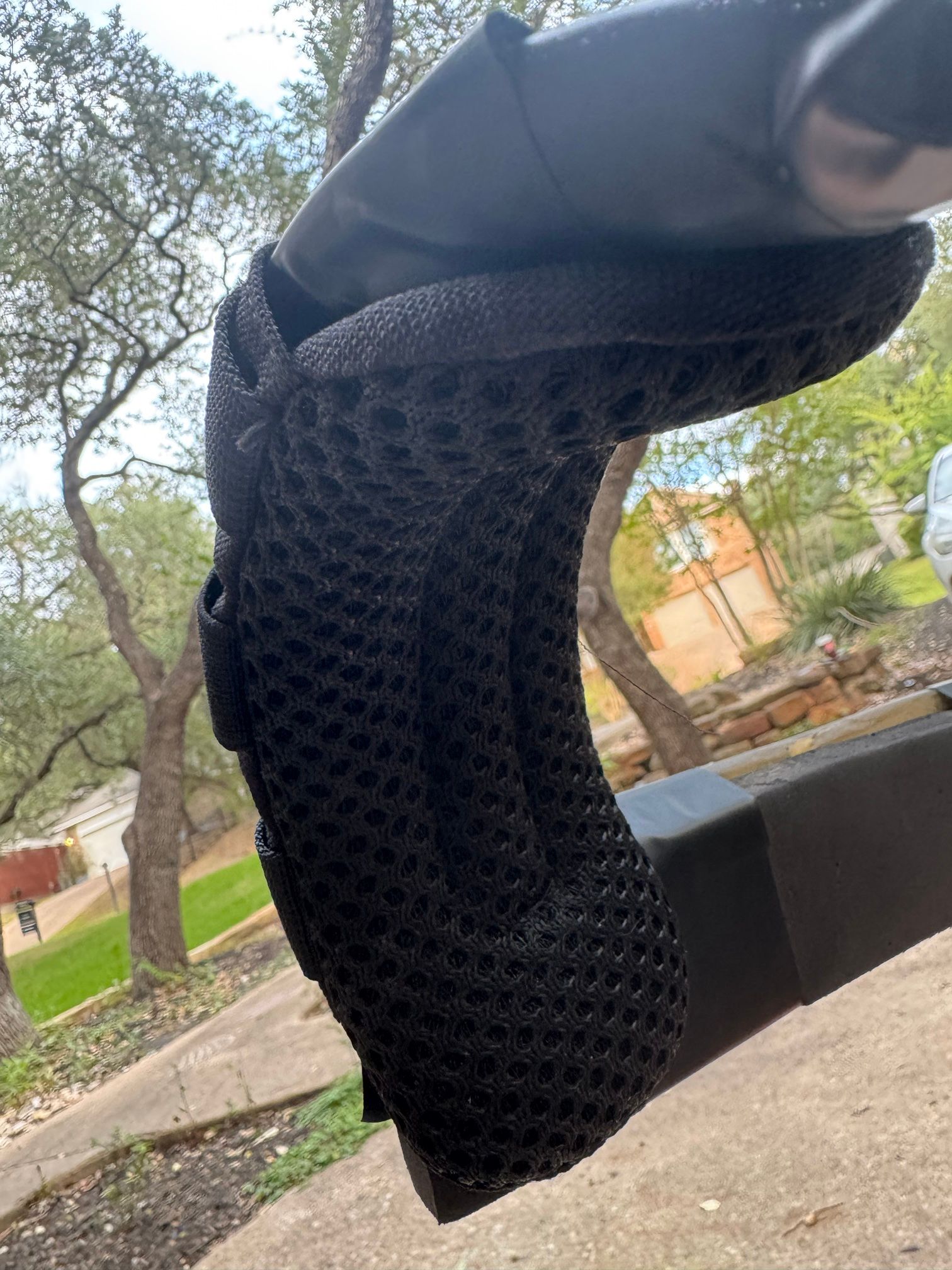 A black mesh tactifans pad wrapped around a harness shoulder bar.