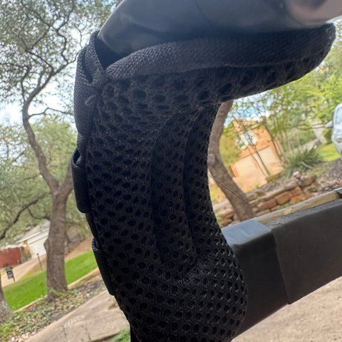 A black mesh tactifans pad wrapped around a harness shoulder bar.